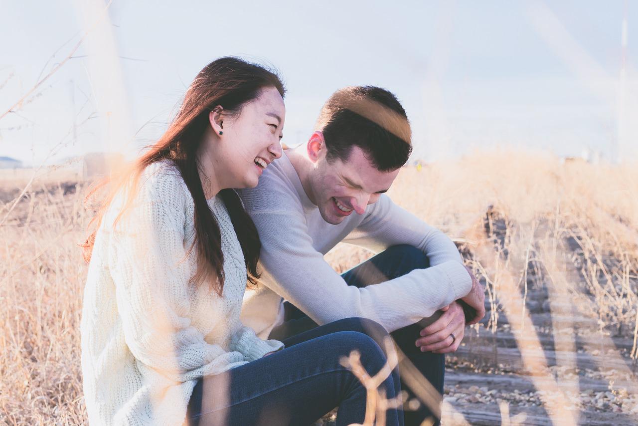 couple laughing to raise vibration